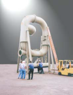 A blue cross is shown in front of a green background.